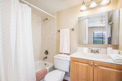 A white toilet sits next to a white sink in a bathroom.