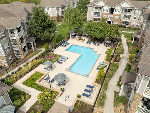 an aerial view of a swimming pool in an apartment complex