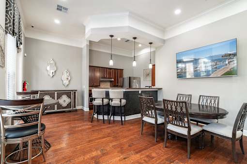 a dining room and kitchen with a table and chairs
