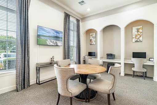 a dining room with a table and chairs