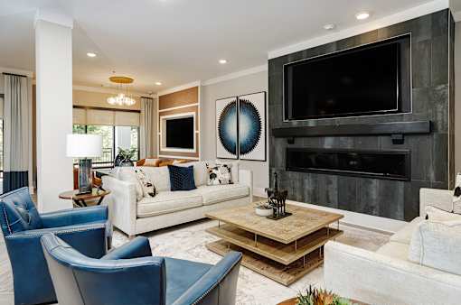 A modern living room with a fireplace and a large TV.