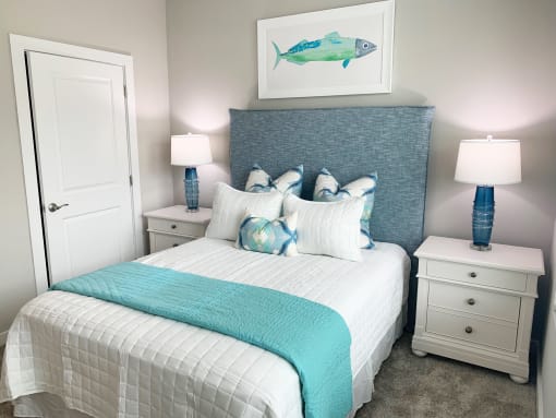 a blue and white bedroom with a bed and a fish