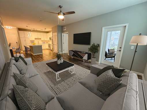 A living room with a grey couch and a coffee table.