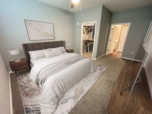 A bedroom with a large bed and a painting on the wall.