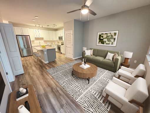 A modern living room with a green couch and a coffee table.