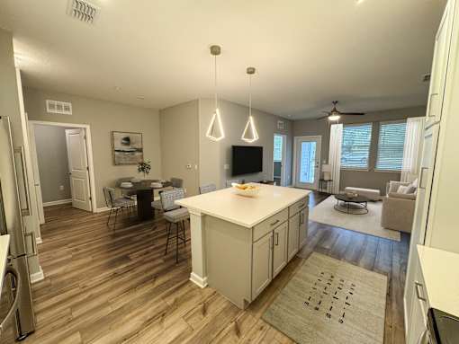 A kitchen with a dining table and chairs.