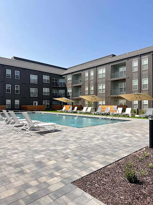 a swimming pool in front of an apartment building