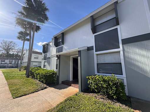 A sunny day at a residential building with a clear blue sky.