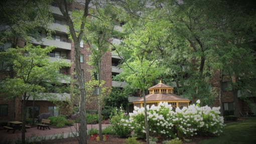 a gazebo in front of an apartment building