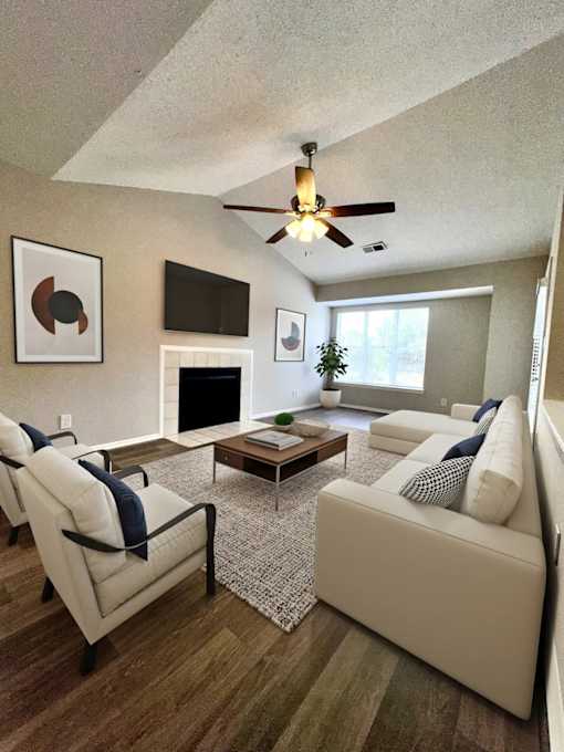 Charlotte, NC, Apartments with In-Unit Washer and Dryer - Coffey Creek - A Living Room With A Vaulted Ceiling With Ceiling Fan, White Sofa, And Chairs.