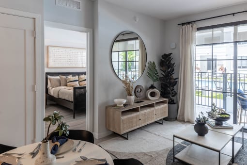 a living room with a large mirror on the wall at Leena Plantation, Florida