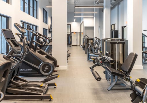 a room filled with cardio equipment and weights at Leena Plantation, Plantation, FL