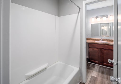 a bathroom with a bathtub and a sink