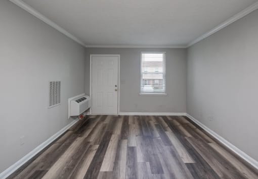 a bedroom with grey walls and a white door
