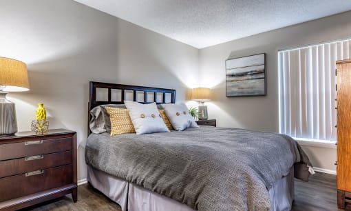 a bedroom with a bed and a dresser and a window at L'Estancia, Florida