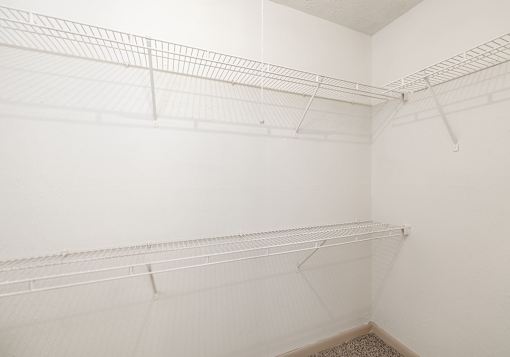 Empty white shelves in a room.