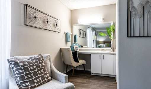 A chair with a pillow is in front of a mirror L'Estancia, Sarasota, FL, 34231