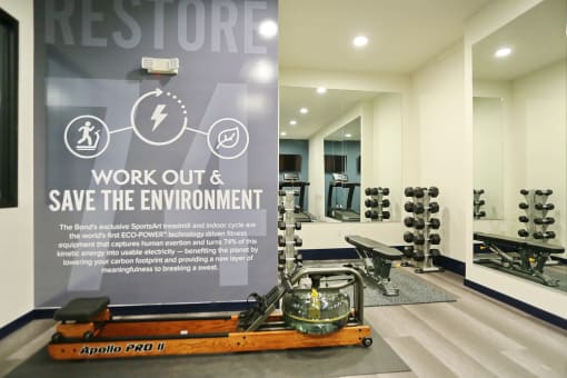 a banner in a gym with the words work out and save the environment
