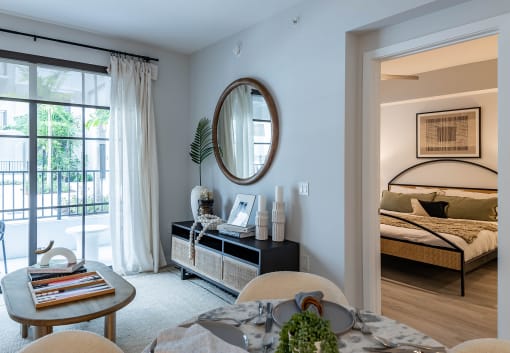 a bedroom with a bed and a door leading to a balcony at Leena Plantation, Plantation, FL