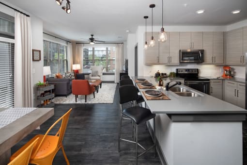 a kitchen and living room with a table and chairs