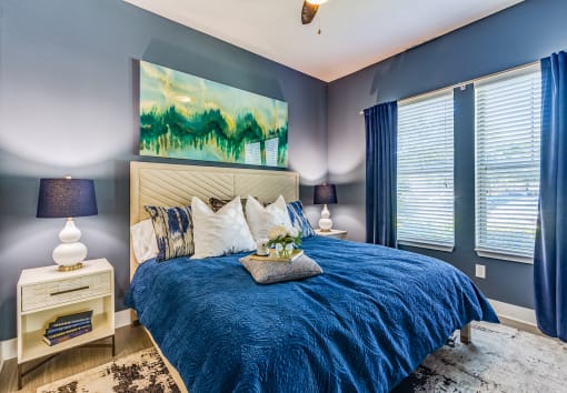 a bedroom with blue walls and a blue and white bed