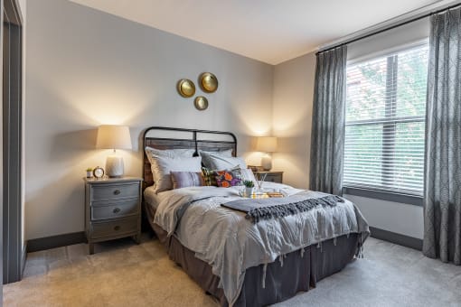 a bedroom with a bed and two windows