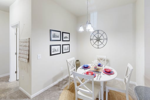 a dining room with a white table and chairs