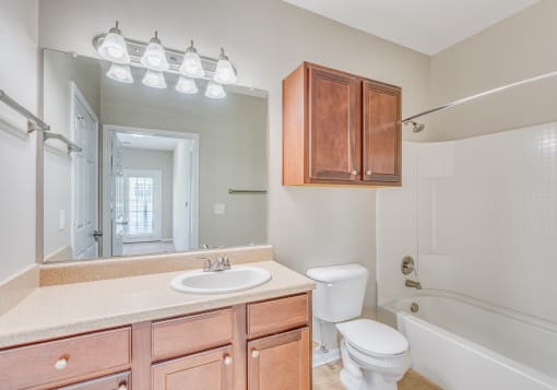 a bathroom with a sink toilet and a mirror