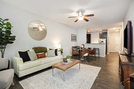 A living room with a white couch and a coffee table.