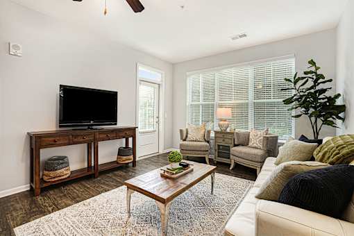A living room with a television and a couch.