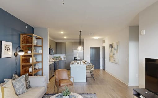 a living room and kitchen with a couch and a table