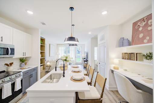 A modern kitchen with a dining table set for four.