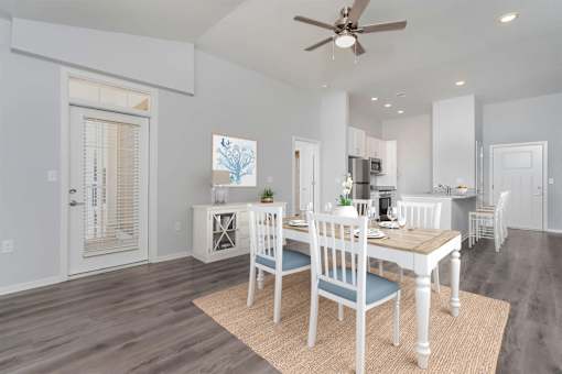 A dining room with a table set for four.