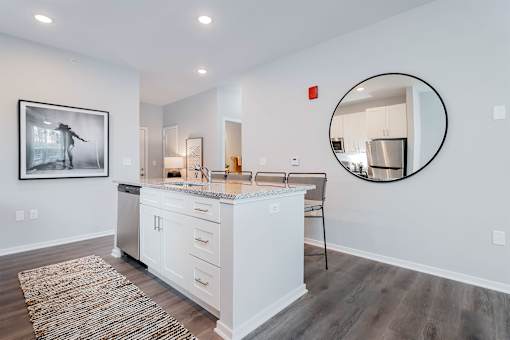 A modern kitchen with white cabinets and a large island.