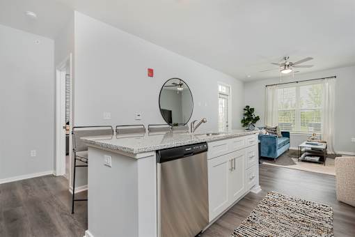 A modern kitchen with white cabinets and a large island.