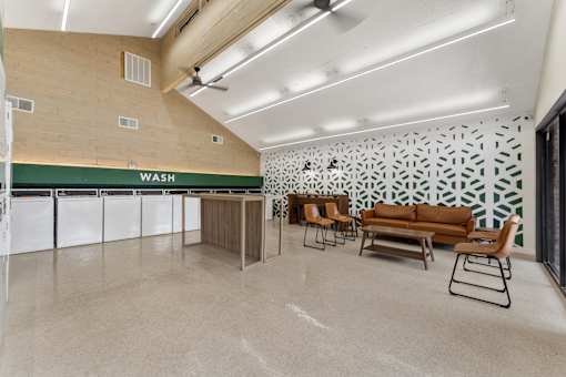 A laundry room with a wash sign on the wall.