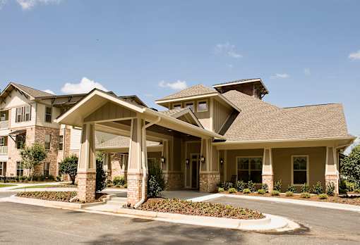 A large, well-maintained house with a spacious front yard.