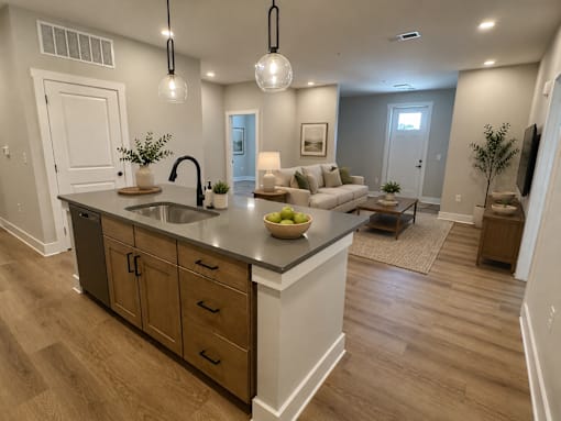 A kitchen with a large island and a dining area.