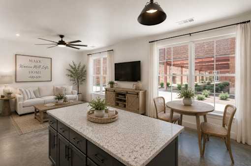A modern kitchen with a large island and a dining table set up.