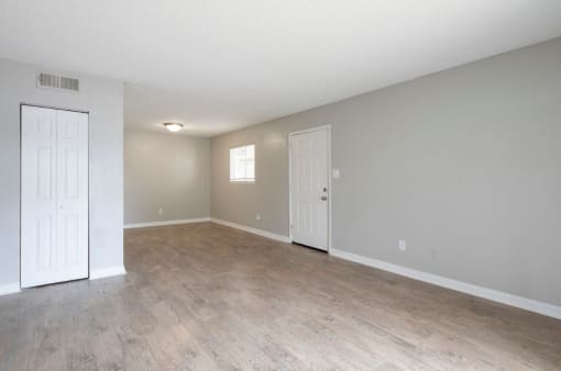 an empty living room with a white door