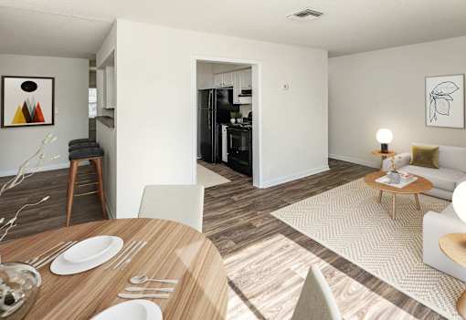 A modern dining room with a wooden table set for two.