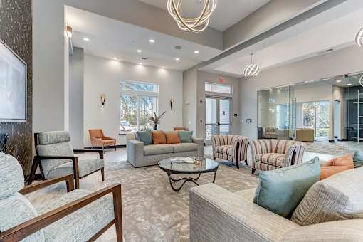 A living room with a couch, chairs, and a coffee table.