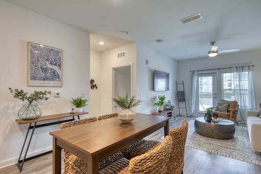 A dining room with a wooden table and chairs.