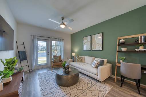 A living room with a white couch and a coffee table.
