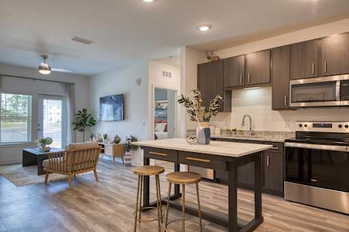 A modern kitchen with dark wood cabinets and stainless steel appliances.