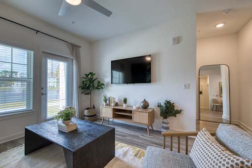 A living room with a black coffee table and a grey sofa.