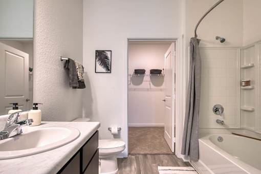 A bathroom with a white tub and a white toilet.