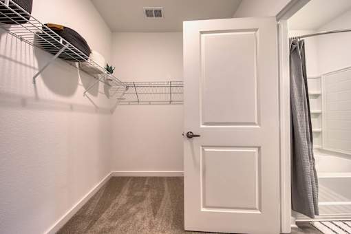 A white door is open to a bathroom.