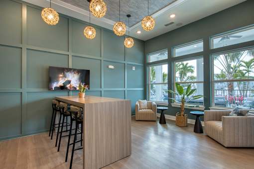 A modern living room with a bar area and a flat screen TV.