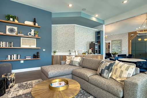 A living room with a grey couch and a wooden coffee table.